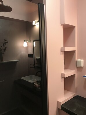 Bathroom features a shower enclosure, sink, and mirror.