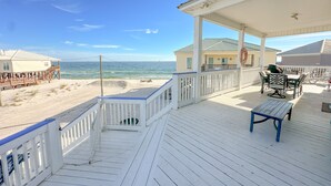 A wooden deck with a view of the beach and ocean. - Dauphin Tale - Family Friendly Gulf View Home only Steps to Gulf of Mexico (Dauphin Island)