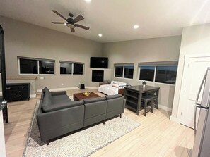 A modern living room with a sofa, coffee table, and TV.