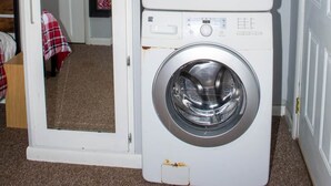 A compact laundry room with two stacked front-loading washing machines. - Winterplace E102 Ski in Ski out First Floor (Ghent)