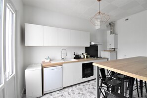 Enjoy meals at the stove and dining table in this kitchen.