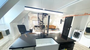 A modern kitchen with a black countertop, white cabinets, a built-in dishwasher, and a black oven. - Victorian architecture dipped in refined modernity. May-June-July special!!! (Portland)