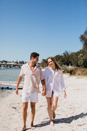 Stroll hand in hand along the beach, taking in the serene views of the ocean and surrounding landscape.