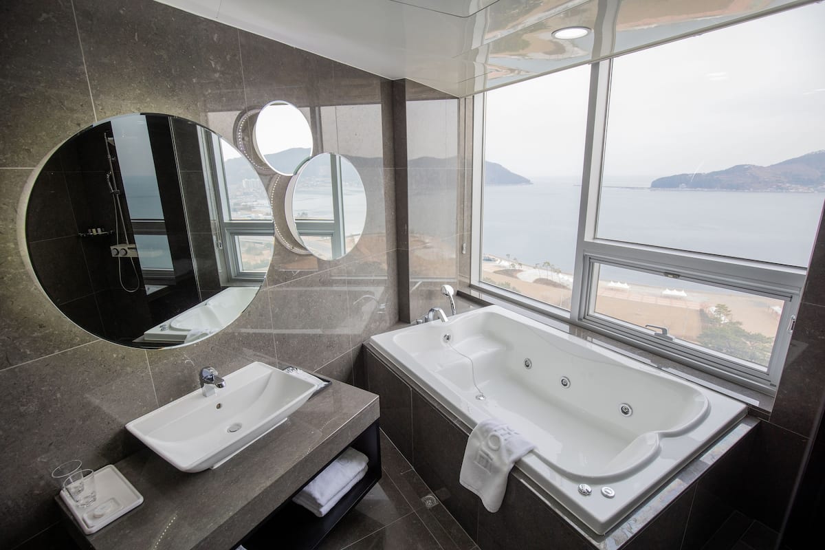 corner royal suite | bathroom | deep-soaking bathtub, hair dryer, slippers, bidet