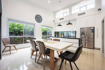 Meals at home are made easy with a long dining table adjacent to the kitchen.