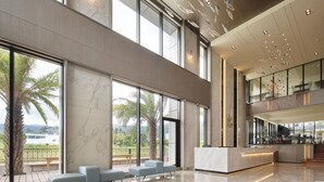 A spacious lobby with large windows, a reception desk, and seating areas. - Lan Yang Seaview Hotel (Toucheng)