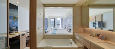 A modern bathroom with a bathtub, a sink, and a mirror.