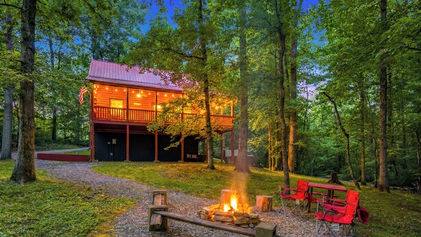 A cabin with a deck, a fire pit, and red chairs. - Log Cabin, UTK/Neyland, Smokies, 16acres, FP, HotTub, GameRoom, Fishing, Pets (Knoxville)