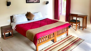 A bedroom with a bed, bedside tables, a desk, and a window with curtains. - Majkhali Woods, Ranikhet, By Himalayan Eco Lodges (Ranikhet)