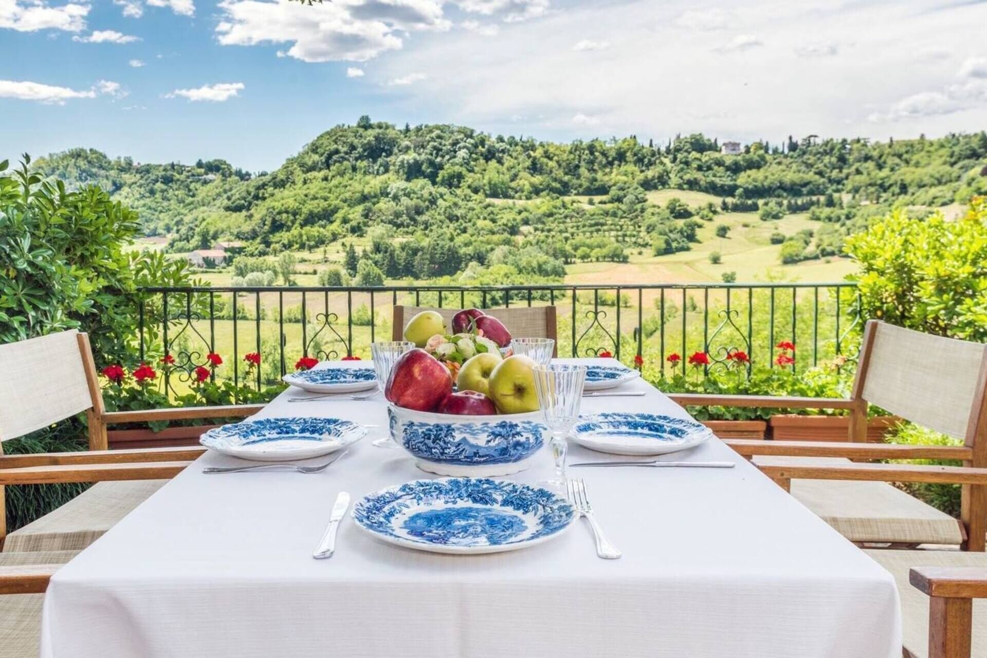 Ein Tisch ist für eine Mahlzeit mit Blick auf eine üppige, grüne Landschaft gedeckt.
