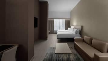 Et moderne hotelværelse med seng, sofa, lille bord og fjernsyn.