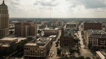 A cityscape with various buildings, including a prominent church with a green roof, surrounded by other structures and a river.