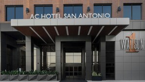 The exterior of AC Hotel San Antonio with a modern design, featuring a prominent entrance and the name 'Watson' on the right side.