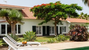 A poolside area with lounge chairs, a small table with fruit, and a tiled pool. - CORONEL - CASERÍO DE GUAZA (Palm-Mar)