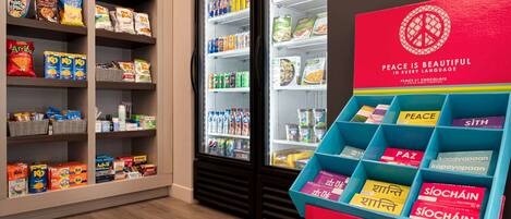 A snack display with various packaged foods and a promotional stand for chocolate.