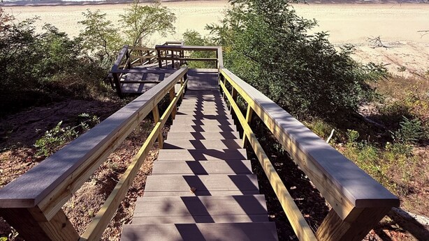 A wooden boardwalk leading to a beach with clear blue water and a sandy shore. - Cottage on the Bluff - NEW Stairs to the Beach, Hot Tub & Unbeatable Sunsets! (South Haven)