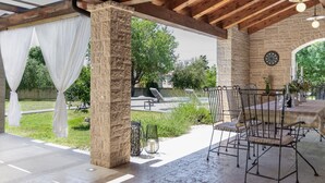 An outdoor patio with stone pillars, a covered seating area, and a dartboard. - Modern Villa for 10 persons  is settled in the small village of Barban (Barban)