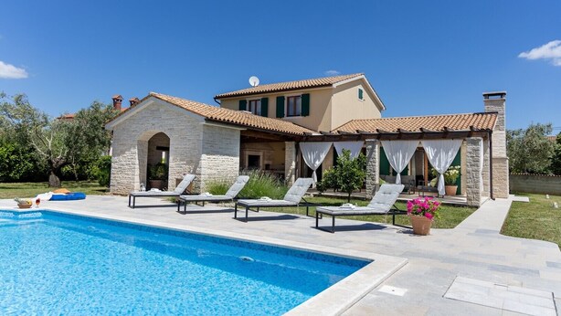 A two-story house with a swimming pool, stone walls, and a covered patio area with lounge chairs. - Modern Villa for 10 persons  is settled in the small village of Barban (Barban)
