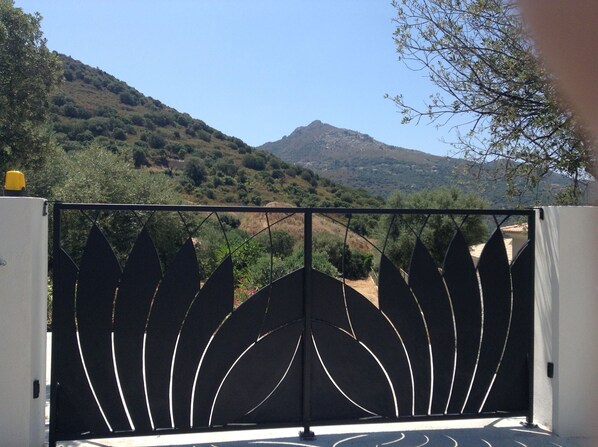 A gated entrance with a mountain view.