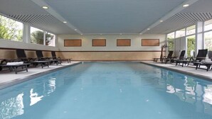 An indoor swimming pool with lounge chairs and a ceiling with recessed lighting. - Vacation apartment in Haus Wiesenblume: Apartment 1 (Willingen-Usseln)