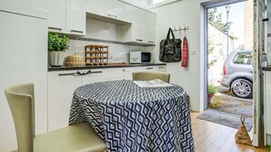 A modern kitchen with white cabinets, a microwave, and a hanging bag. - High Trees Blenheim View | Woodstock Holiday Let | 3 Beds & Sleeps 5 (Woodstock)