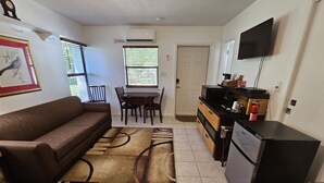 A compact living space with a sofa, dining table, and kitchenette. - Great quiet and comfortable, South Central Lakeland location. (Lakeland)