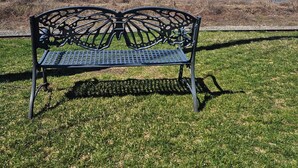 A park bench facing a body of water with a clear sky. - Relax in our large 4b/2b ranch w/hot tub,firepit, game room, sleeps 11, pets ok (Sawyer)