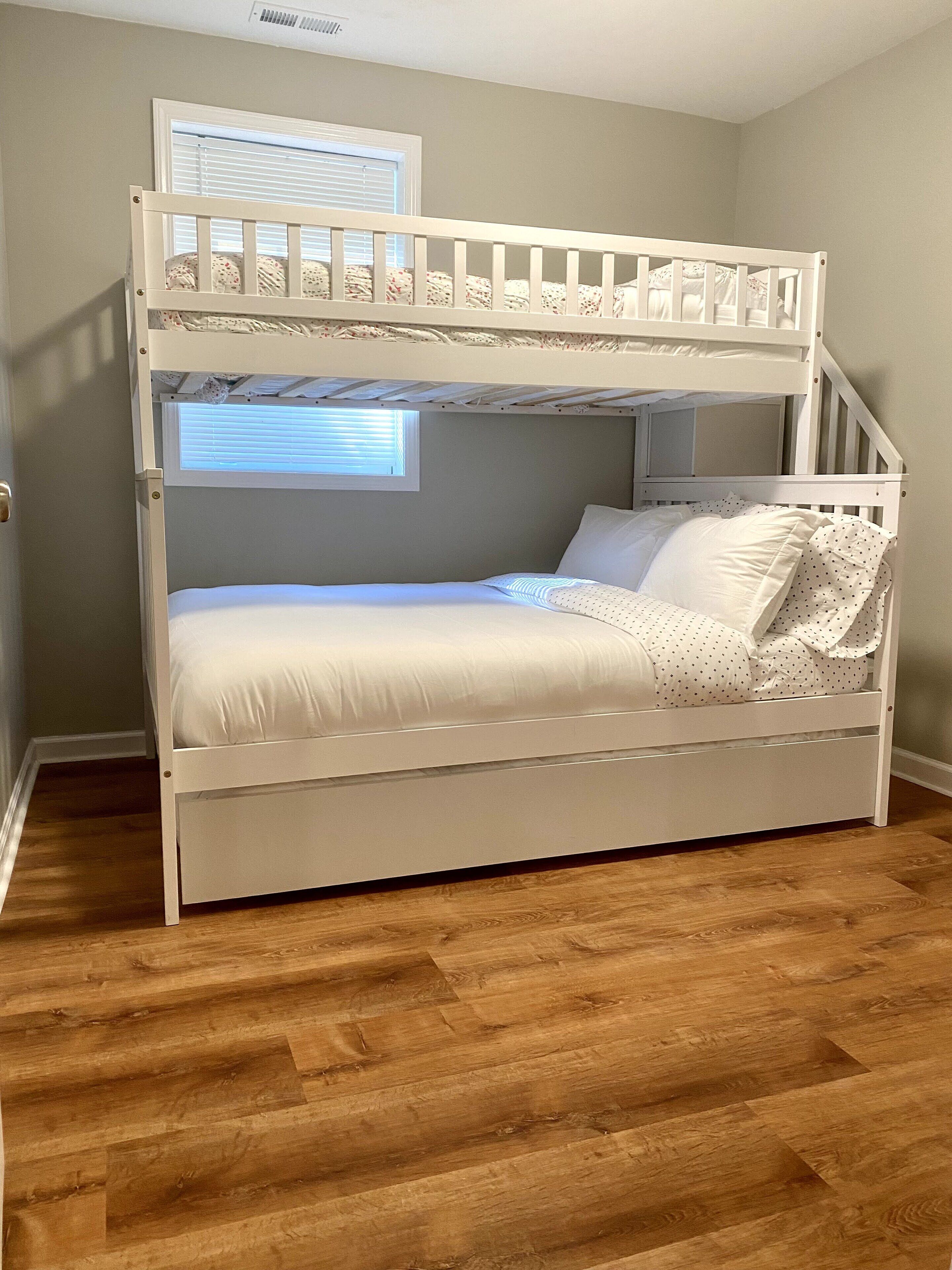 A bunk bed with a window above the lower bunk.
