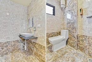 A bathroom with a marble floor, a sink, and a toilet. - Hotel Manik (Chhatrapati Sambhajinagar)
