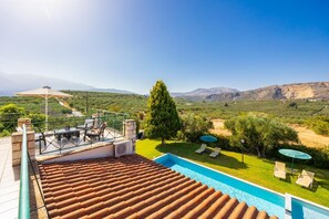 A rooftop terrace with a swimming pool, outdoor seating, and a scenic view of mountains. - Villa Dimitris - Three Bedroom Villa, Sleeps 6 (Apokoronos)