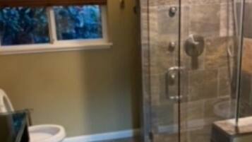 Combined shower/bathtub, towels, soap, toilet paper