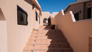 A narrow, sunlit corridor with terracotta tiled steps leading to a door. - OCEANFRONT - Stunning, unobstructed views! (San Carlos Nuevo Guaymas)