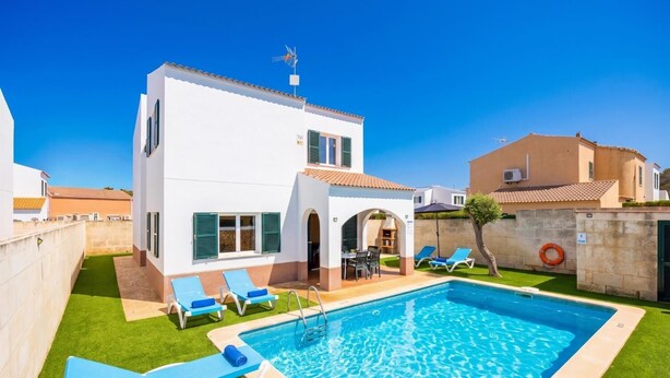 A two-story building with a swimming pool, outdoor seating, and a clear blue sky. - Villa La Luna - Three Bedroom Villa, Sleeps 6 (Ciutadella de Menorca)