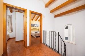 A hallway with a bed, a window, and a staircase. - Villa La Luna - Three Bedroom Villa, Sleeps 6 (Ciutadella de Menorca)