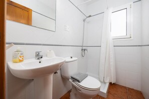 A bathroom with a white sink, toilet, and shower. - Villa La Luna - Two Bedroom Villa, Sleeps 4 (Ciutadella de Menorca)