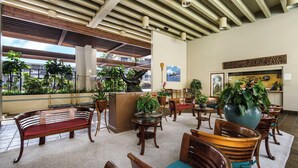 A spacious lobby with wooden furniture, potted plants, and a view of the outdoors. - Lovely Oceanfront 2/Bdrm, 4th Floor Condo with A/C at the Kona Bali Kai Resort (Kailua-Kona)