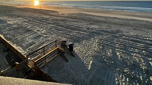 A beach view with a wooden staircase leading down to the sand. - Recently Renovated OCEANFRONT CONDO Directly on Beach w/2 bedrooms and 2 baths. (Myrtle Beach)