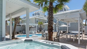 A pool area with a hot tub, lounge chairs, and umbrellas. - Across Beach, Pool, Pool Table,Ping Pong, Golf Cart Rental, Amazing Yard, 7 BR (Destin)