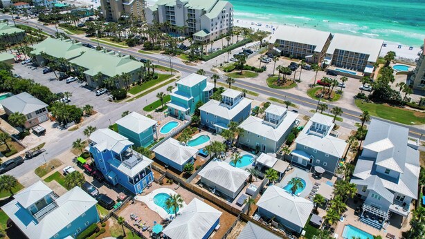 An aerial view of a coastal hotel area with multiple buildings, swimming pools, and a beach. - Across Beach, Pool, Pool Table,Ping Pong, Golf Cart Rental, Amazing Yard, 7 BR (Destin)