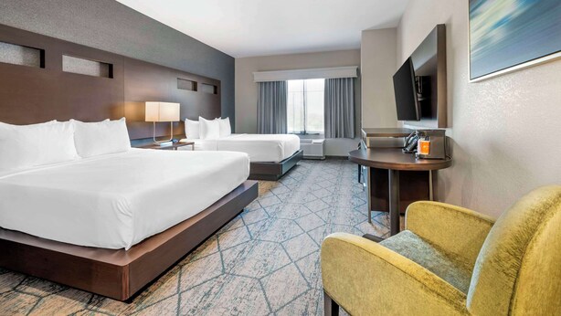 A hotel room with two beds, a TV, a desk, and a chair. - Comfort Inn & Suites Clarksville - Louisville North (Clarksville)