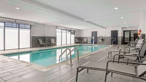 An indoor swimming pool with clear lanes, lounge chairs, and a tiled floor. - Comfort Inn & Suites Clarksville - Louisville North (Clarksville)
