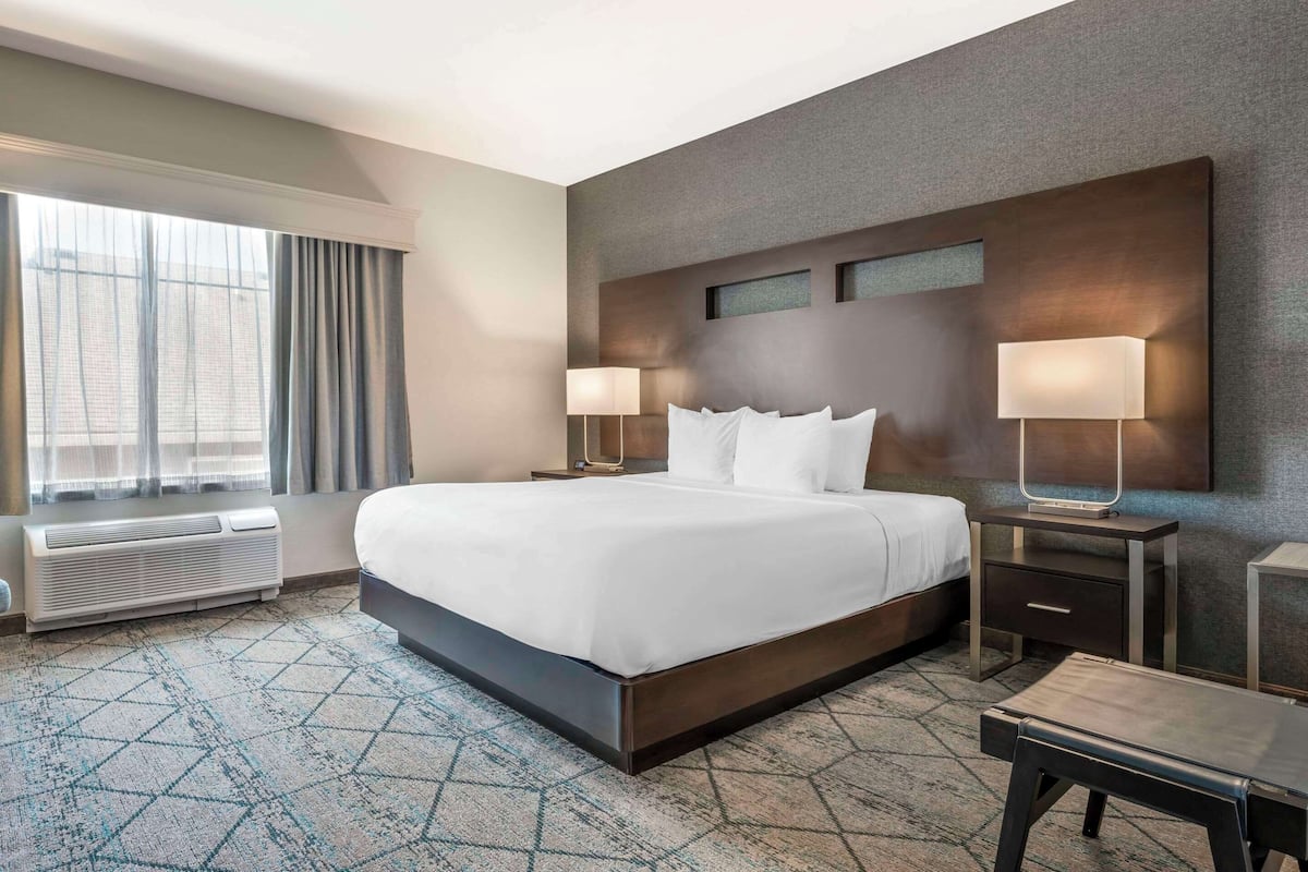 Premium bedding, desk, laptop workspace, iron/ironing board