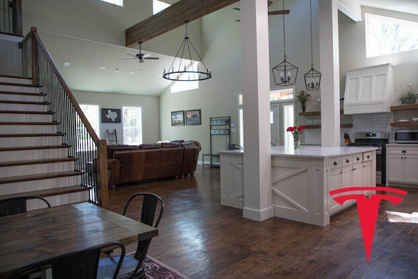 Large open concept living space in front unit with XL kitchen island, gas range.