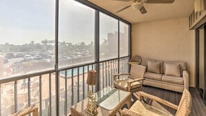 A balcony with a sofa, chairs, and a table. - Burnt Store Marina Condo: Boat, Swim, Golf! (Punta Gorda)