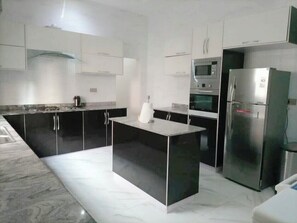 Microwave, cookware/dishes/utensils, dining tables