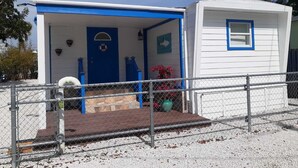 A small, single-story building with a blue door and a white exterior. - 3 MIN FROM PRIVATE BEACH & BOAT RAMP (Key Largo)