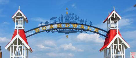 A sign with 'Boardwalk Ocean City Maryland' and silhouettes of beach activities.