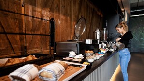 A buffet setup with various food items and a coffee station. - B&B Hotel Oftringen (Oftringen)