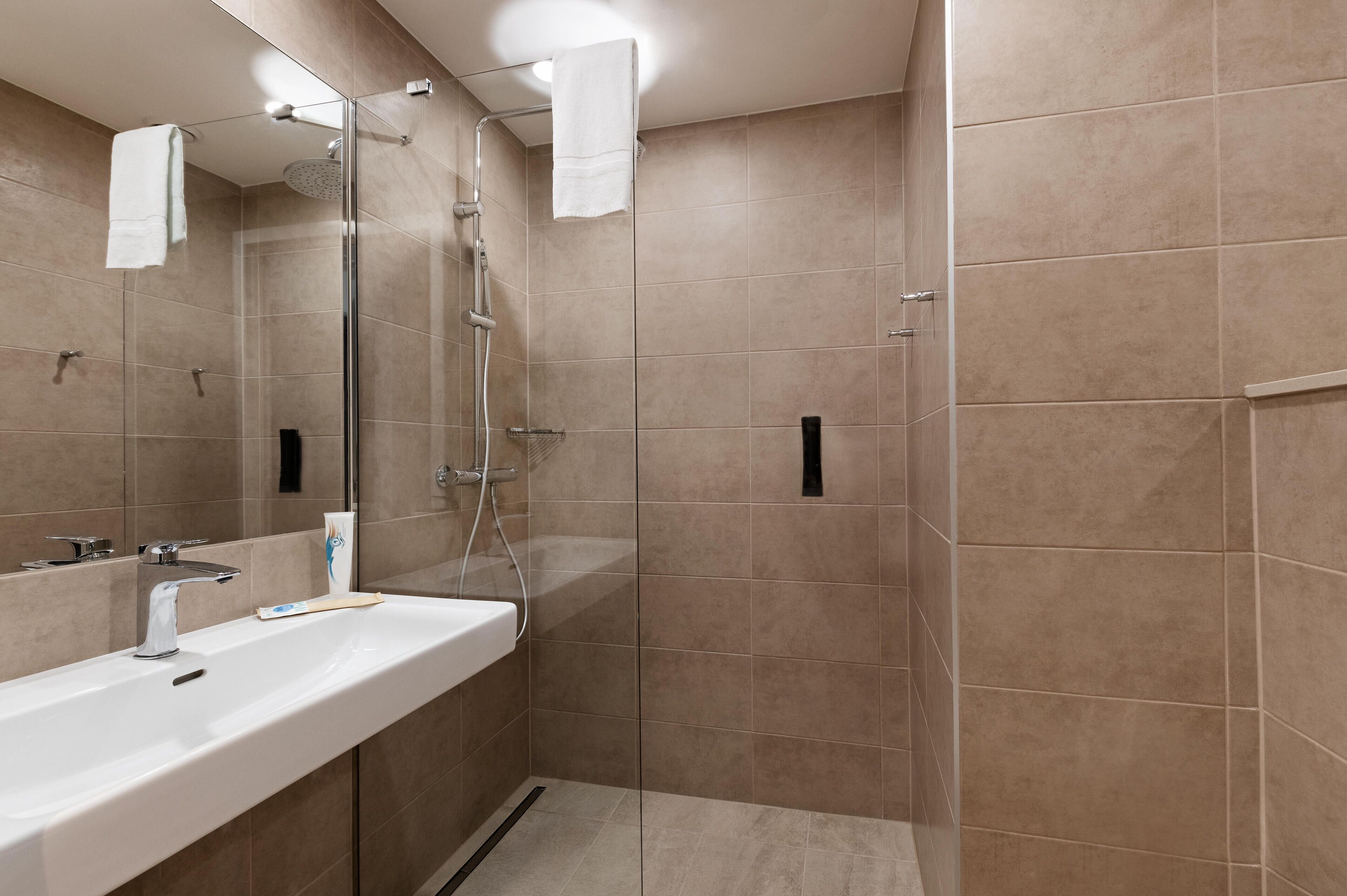 shower, rainfall showerhead, hair dryer, towels