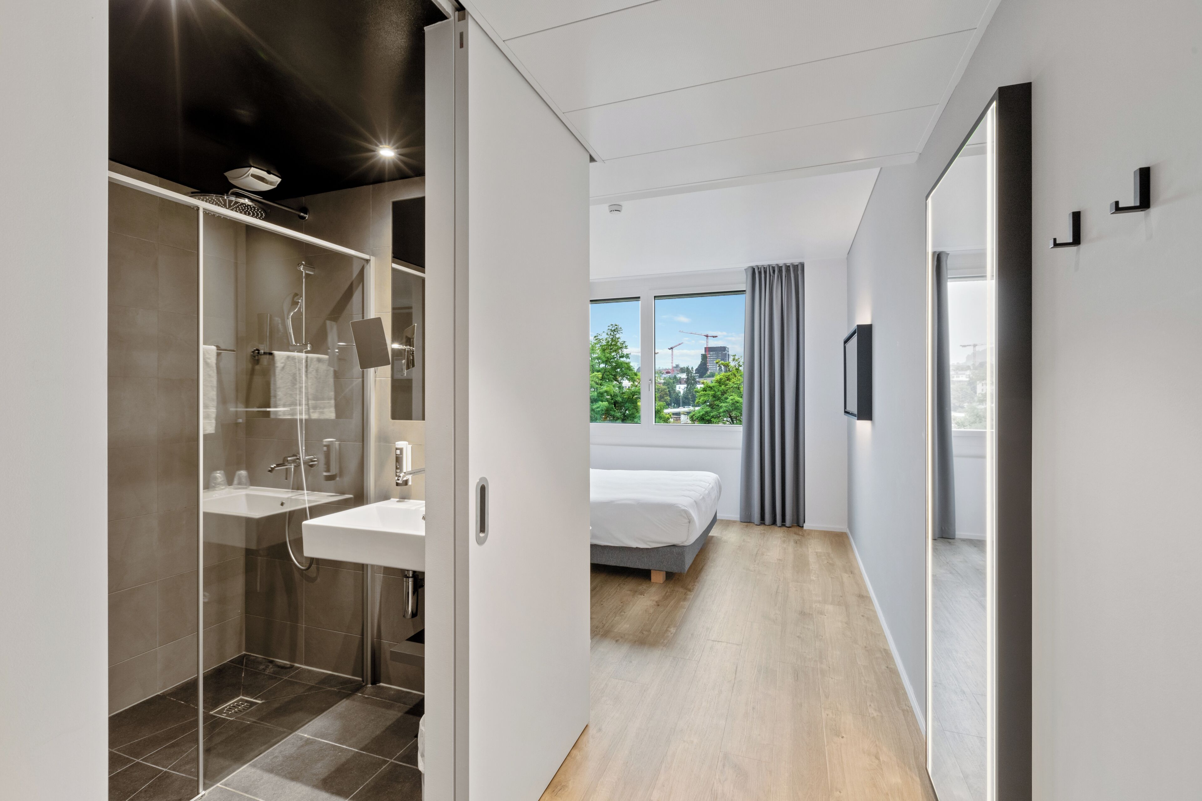 Premium bedding, laptop workspace, blackout drapes, soundproofing